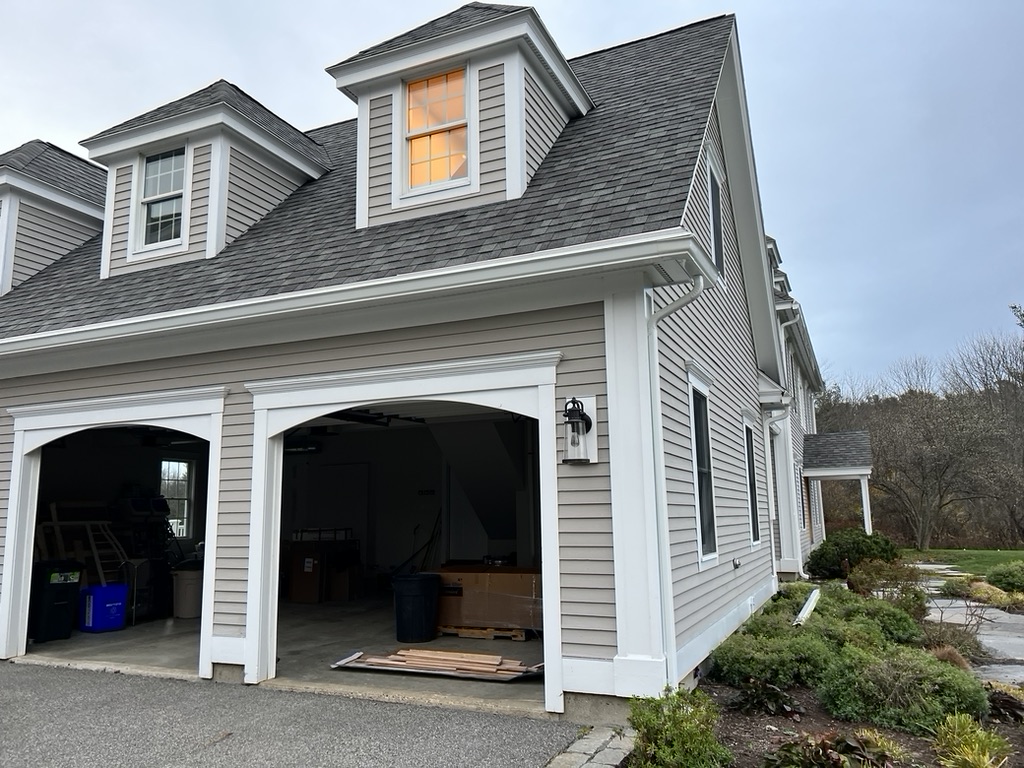 Large gray two-story colonial home with new gutters